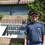 Daniel Palmer, Associated Asphalt Roanoke Terminal Manager in front of an Associated Asphalt sign.