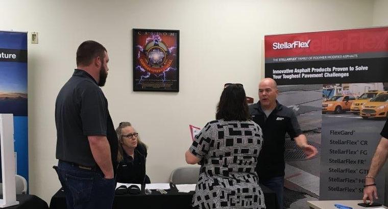 Associated Asphalt employees talking to potential customers about StellarFlex products.