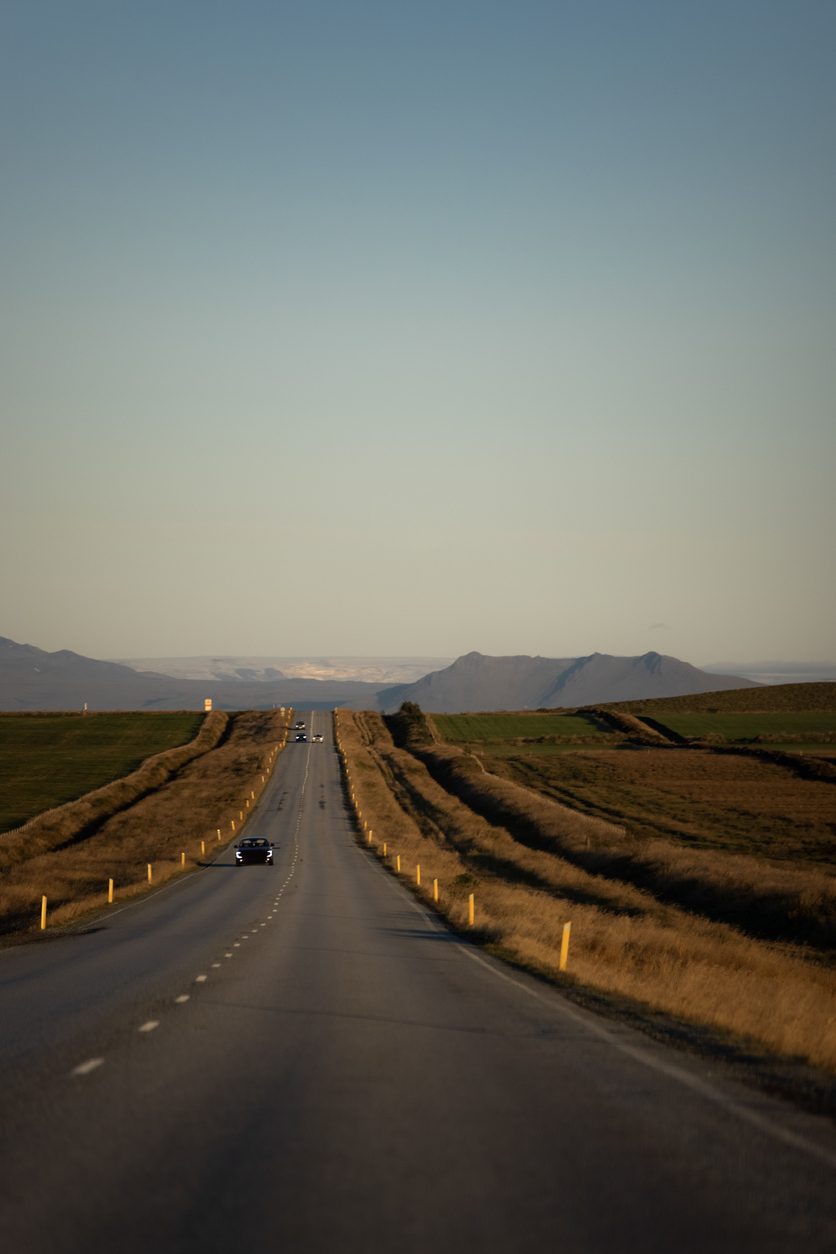 paved road, single car on an open road on iceland, long paved road, liquid asphalt road, asphalt roadways